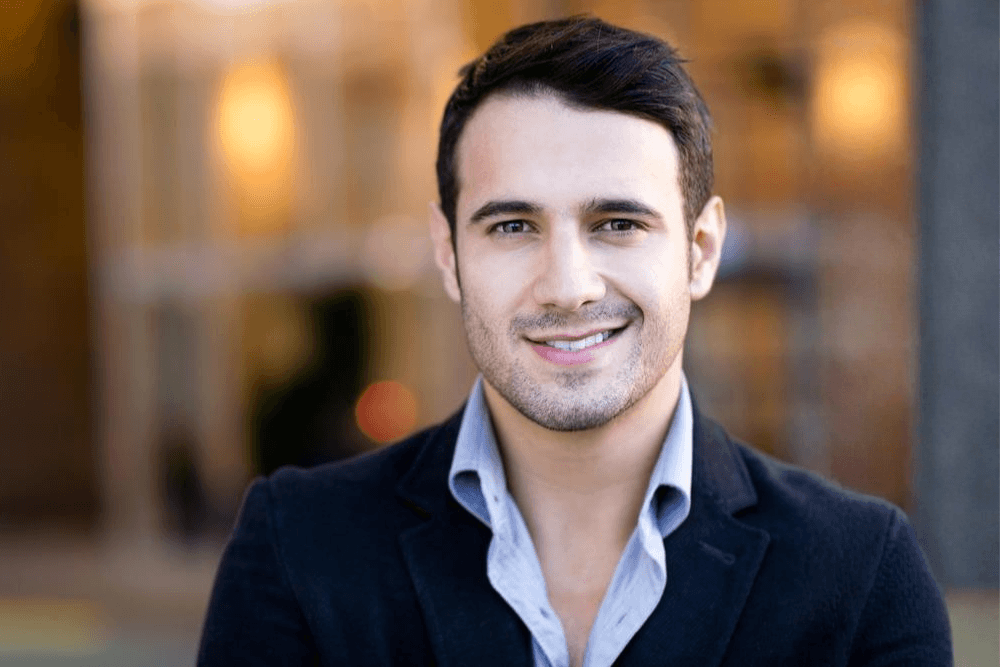 Professional man smiling in a relaxed setting, representing a confident, relationship-ready client